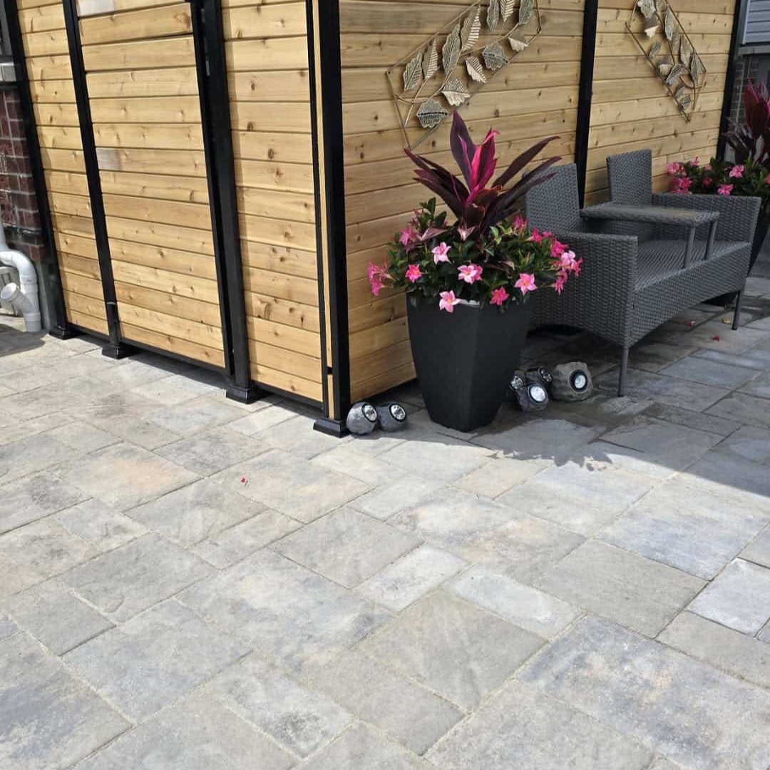 Paver patio and wood privacy screen Paver patio and wood privacy screen creates a modern, custom outdoor seating area, showcasing expertise in both interlock and carpentry/fencing.